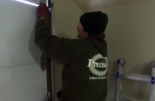 Technician Repairing Garage Door